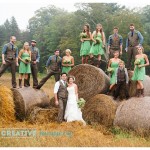 wedding party on bales of hay